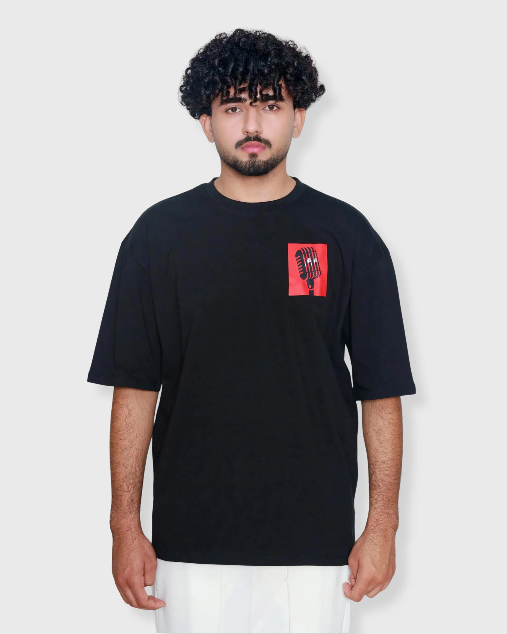 Black oversized box fit t-shirt with small left chest graphic of hands holding a microphone