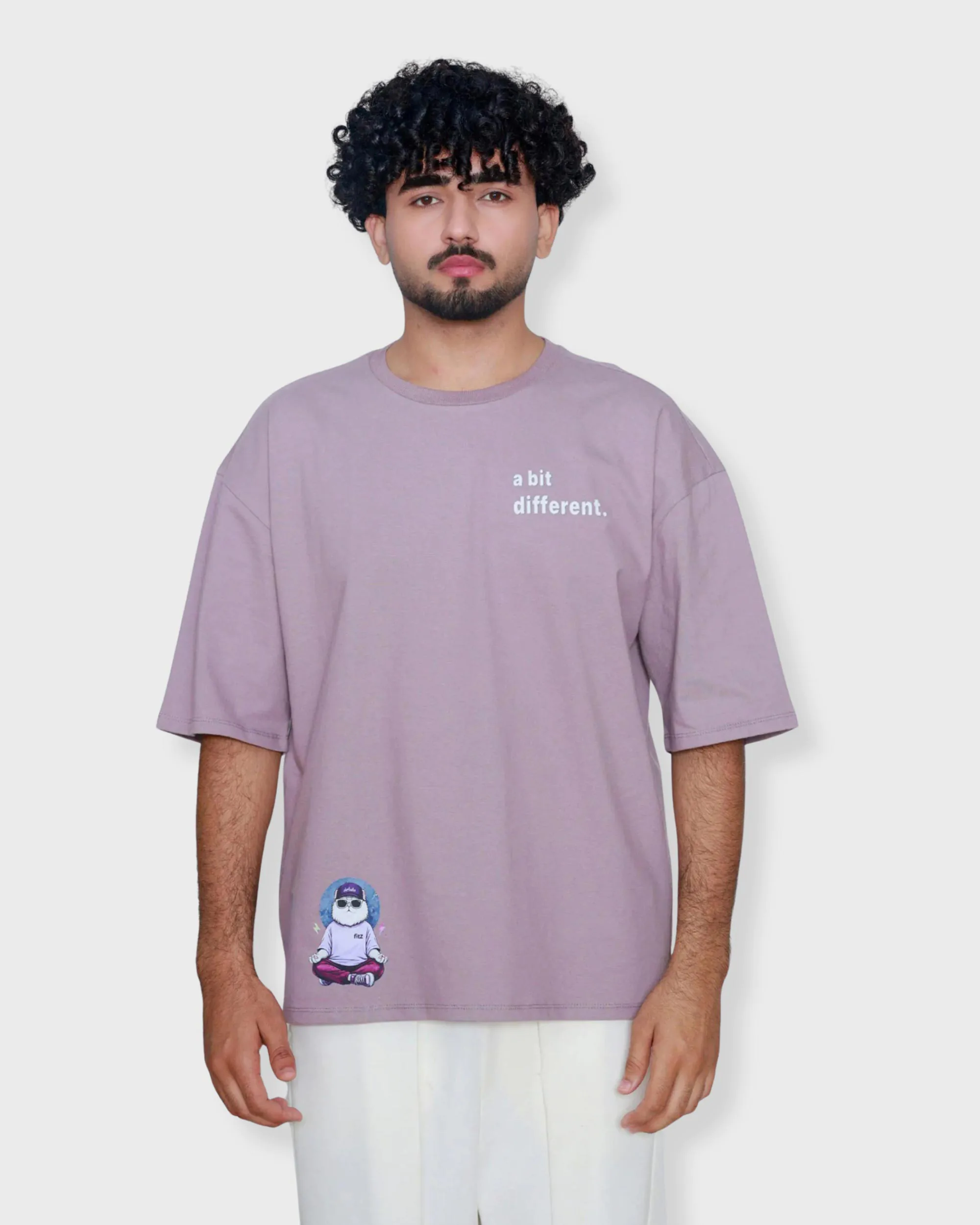 Mauve oversized box fit t-shirt with “a bit different” text on left chest and small graphic print on bottom right