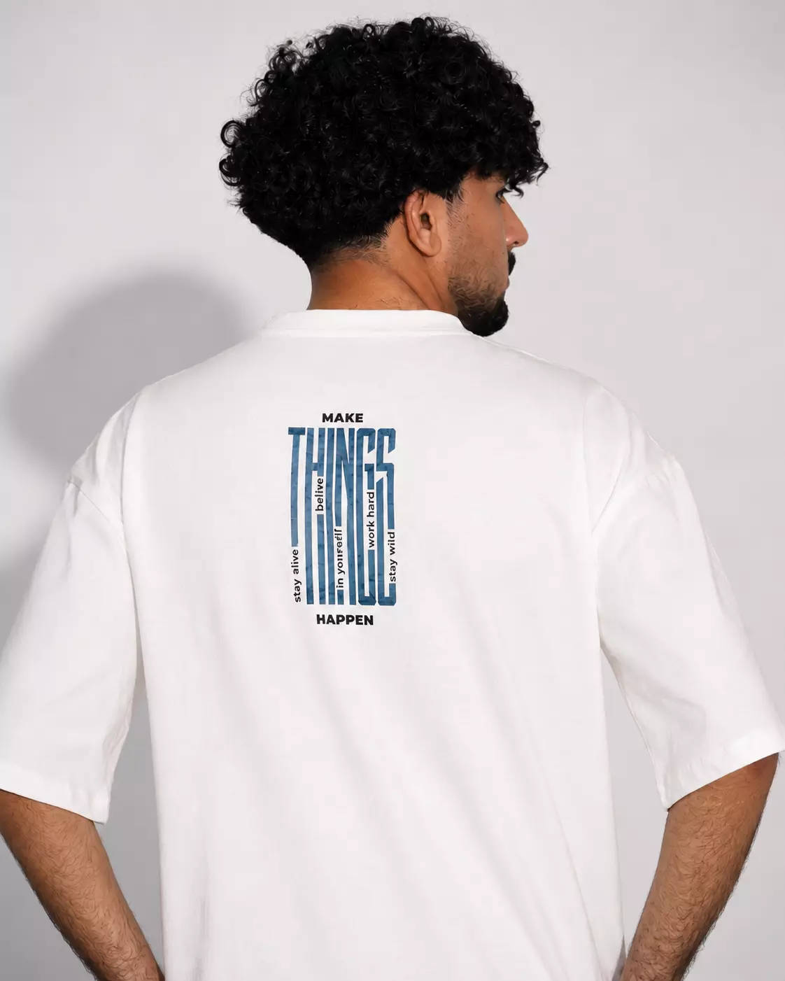 White oversized box fit t-shirt with vertical “Make Things Happen” graphic print on center back